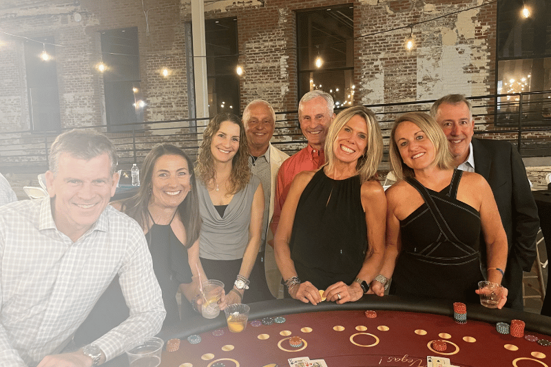 A group of people playing casino games at the Mooresvegas event in North Carolina that is a fundraiser for Pinky Swear Foundation.