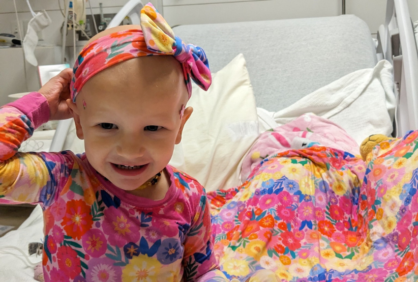 All-Star Mckenna smiling at the camera while in the hospital