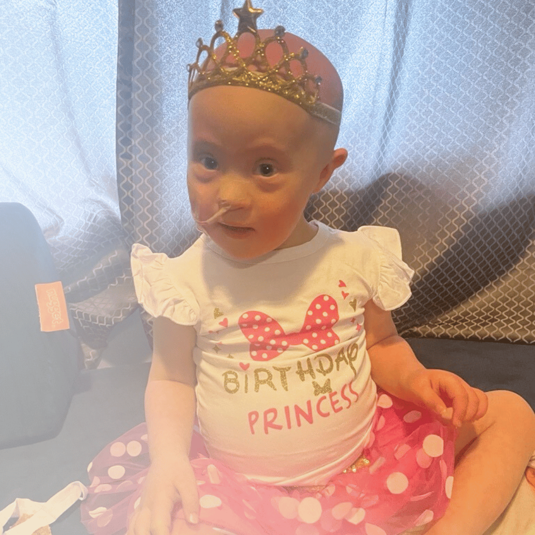 All-Star Kayla with a feeding tube in on her birthday wearing a crown