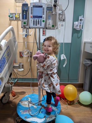 McKenna, teddy and balloons smiling