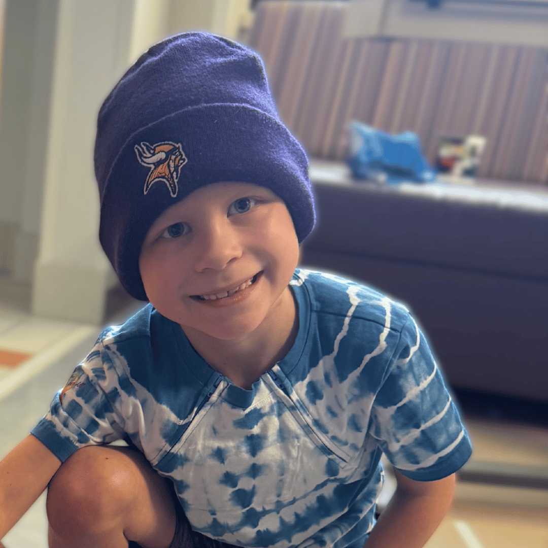 A boy named Ivan wearing a Minnesota Vikings stocking cap who has faced childhood cancer and received financial support from Pinky Swear Foundation.