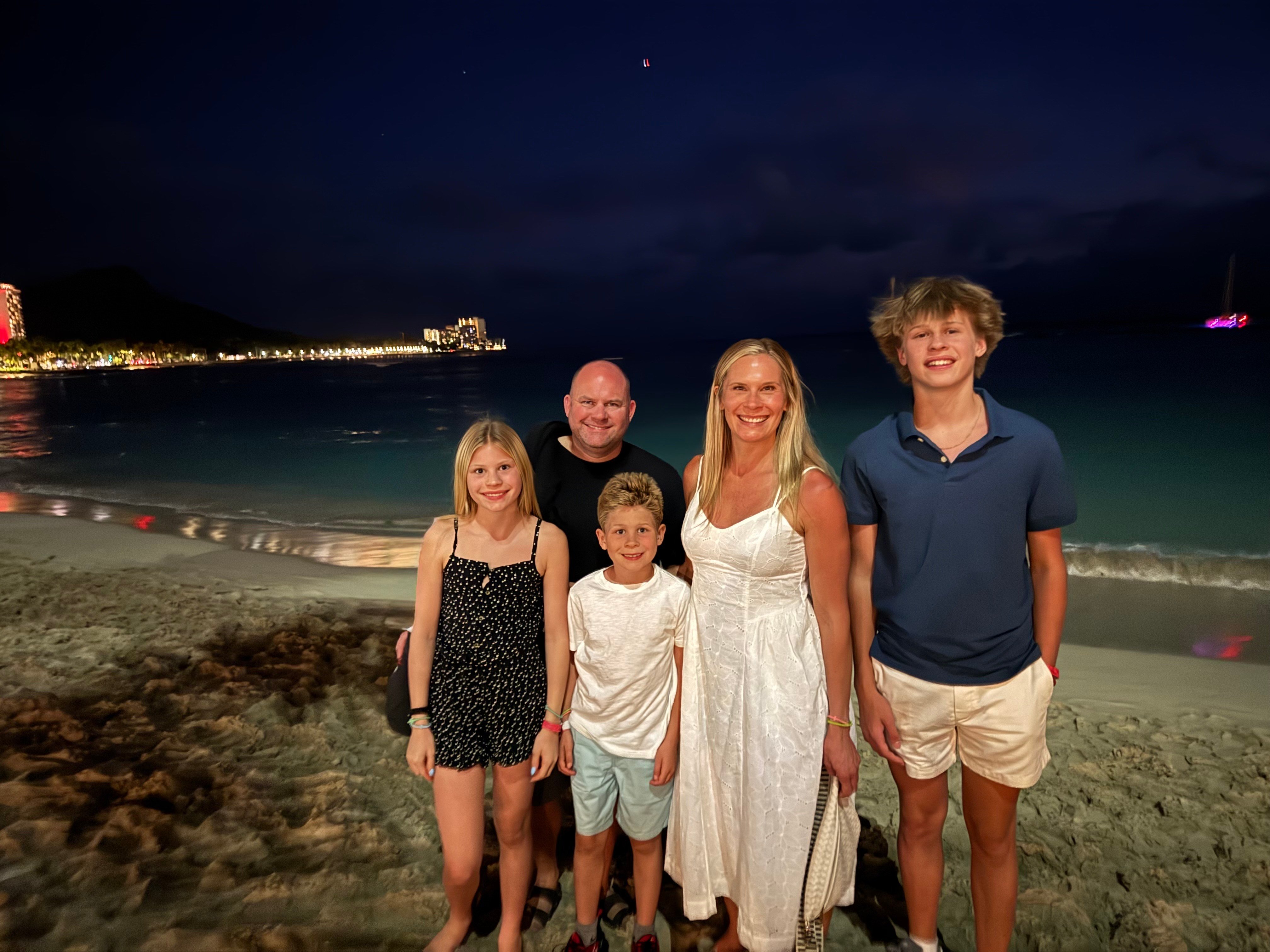 Ivan and family on the beach at night