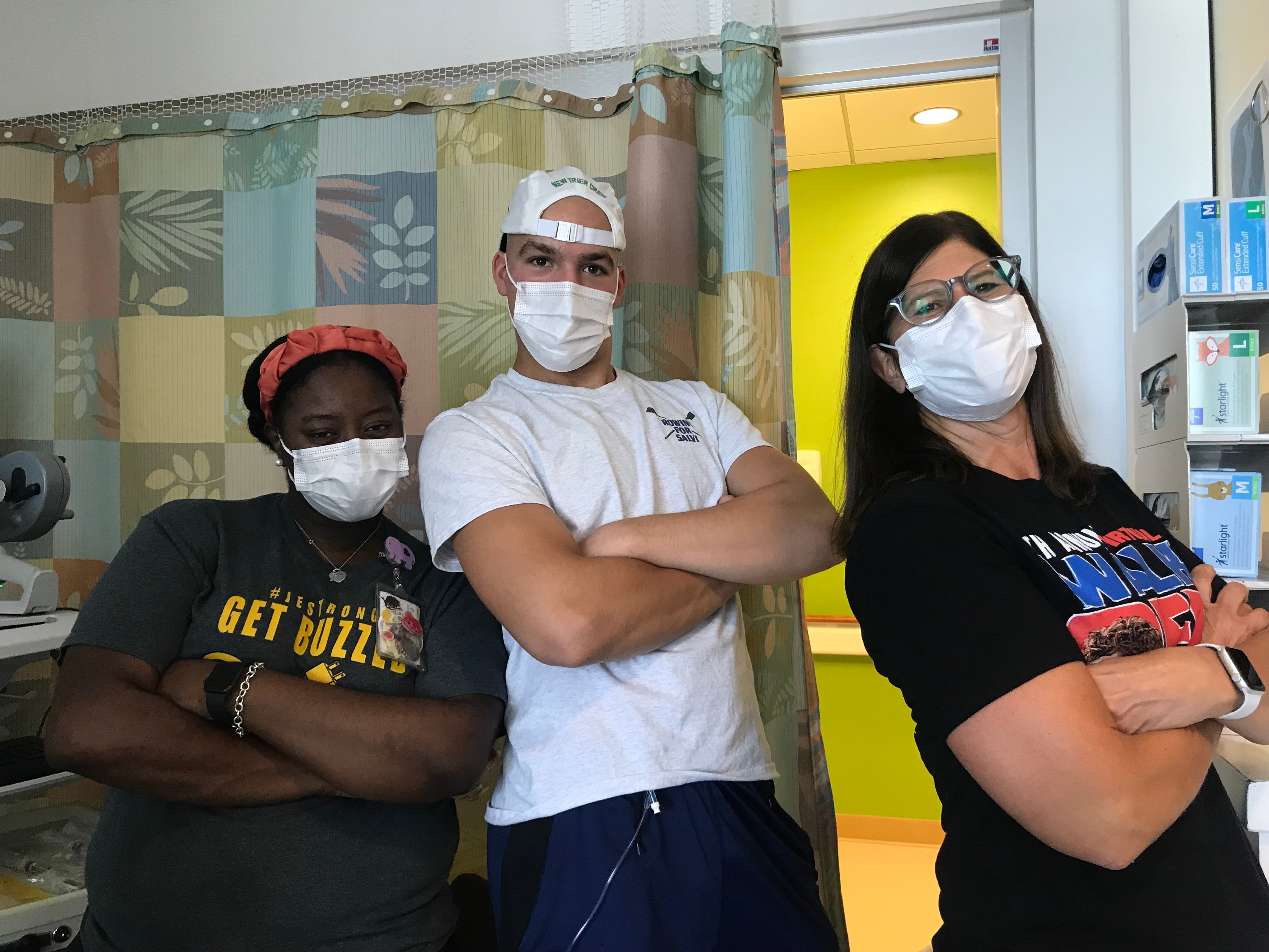 All-Star John with two nurses wearing masks in the hospital during cancer treatment