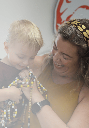 All-Star Barrett holding his beads of courage with his Mom