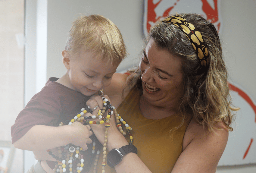 Barrett and his Mom holding his beads of courage