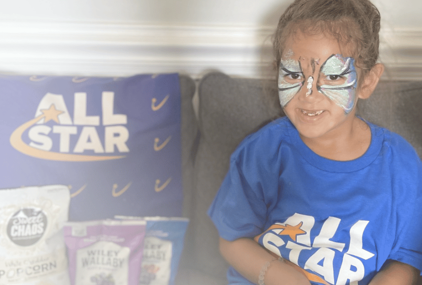 All-Star Amelia sitting on the couch with her All-Star package