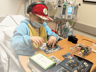 Tenzin playing legos in hospital