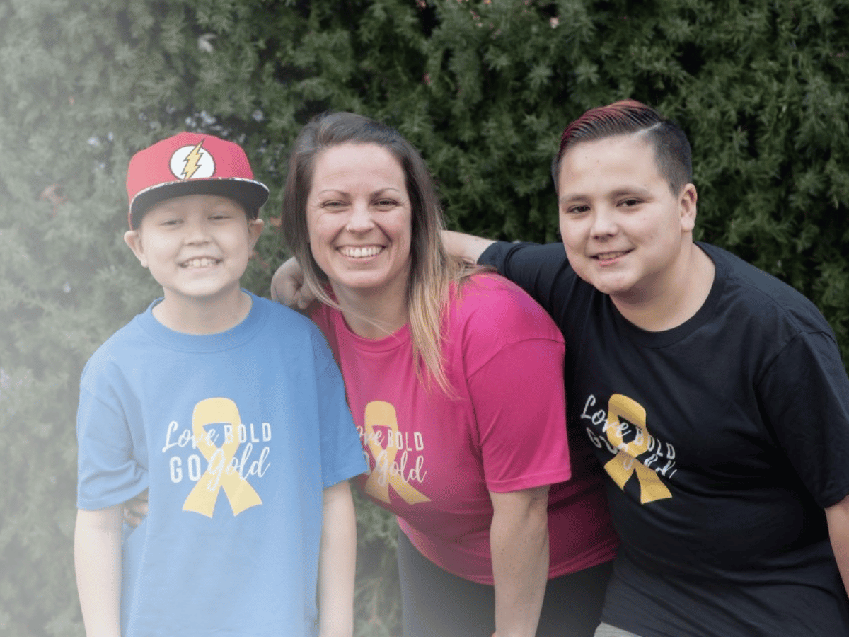 All-Star Tenzin, his mom and brother with Childhood Cancer Awareness Month shirts on