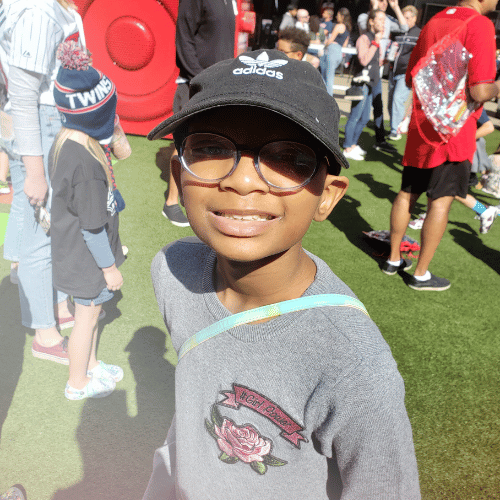 All-Star Terrayah wearing a black Adidas baseball hat and glasses at a Minnesota Twins game