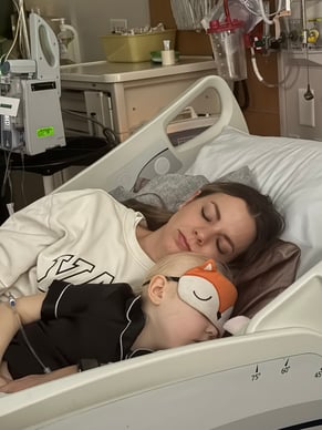 Winnie with teenage sister sleeping in hospital bed