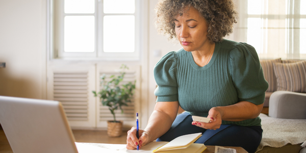 A person assessing finances considering donating to Pinky Swear Foundation through appreciated stock.