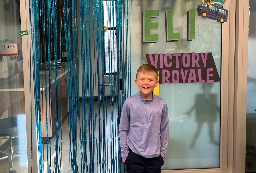Eli is celebrating ringing his bell to end his cancer treatment.