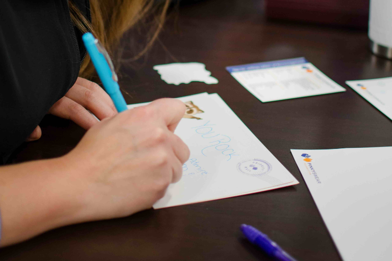 A person creating Letters of Encouragement