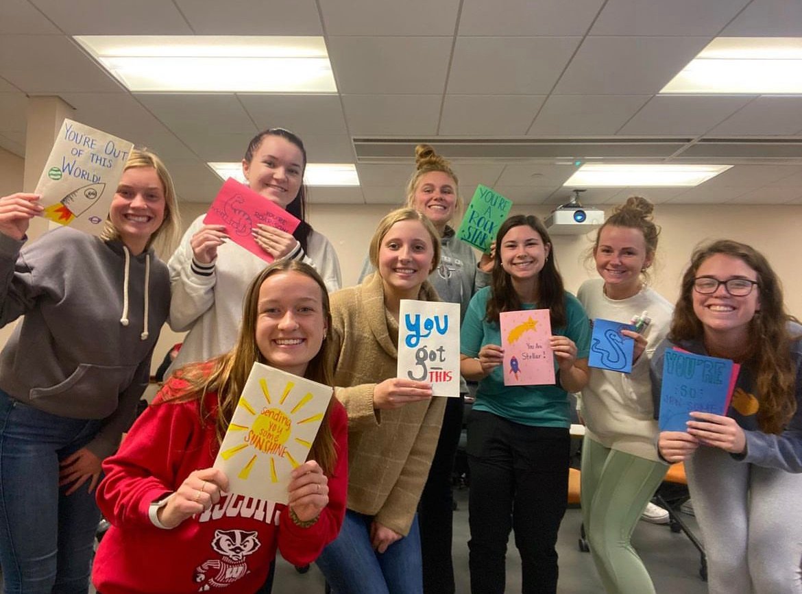 A group of college students holding cards they made for Pinky Swear Foundation All-Star kids and their families dealing with childhood cancer. 