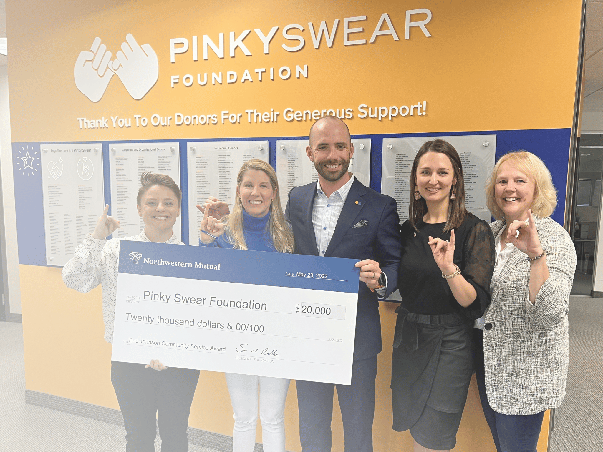 Northwestern Mutual presenting a check to support kids with cancer to Pinky Swear Foundation.