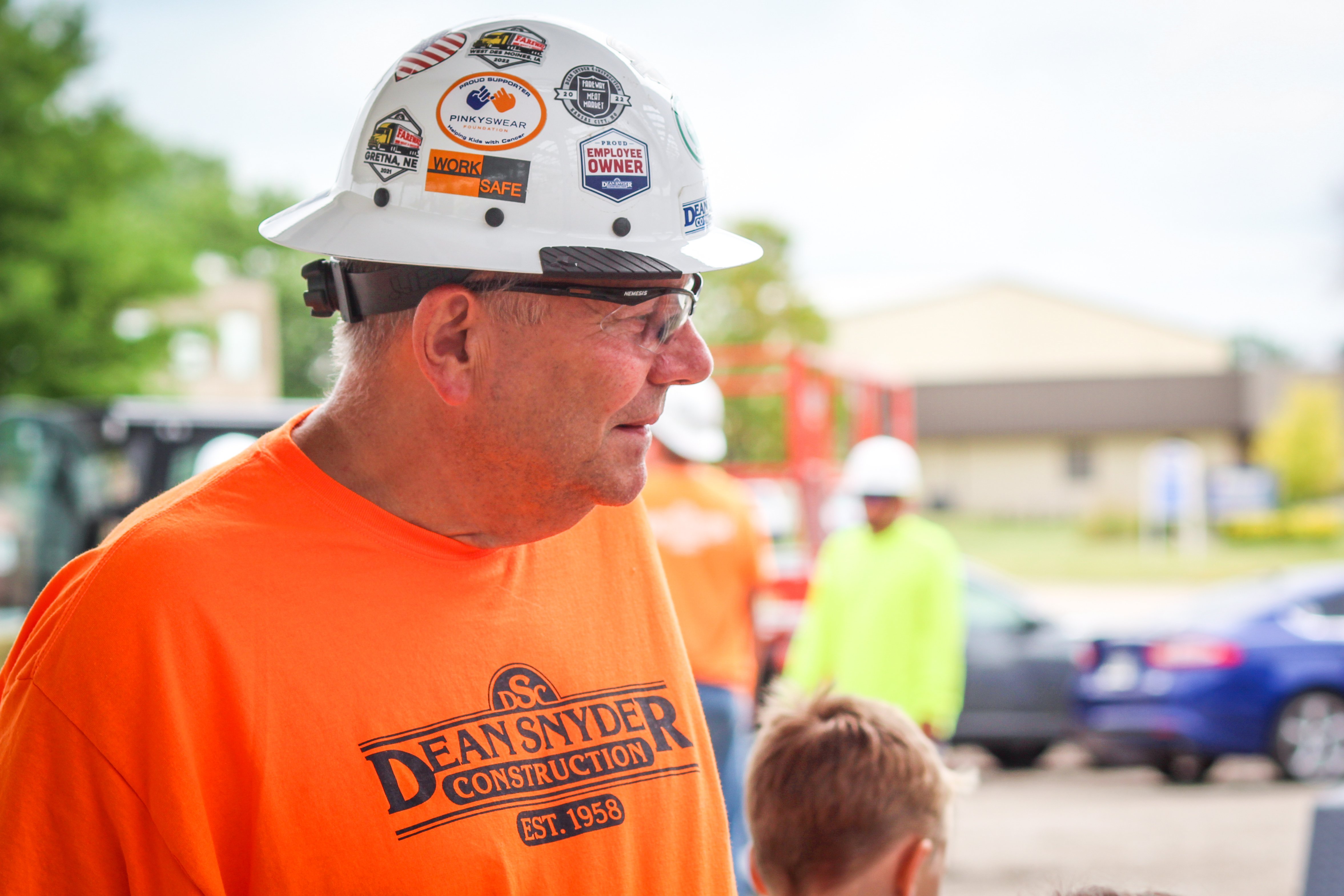 Don of Dean Snyder Construction wearing bright orange and a construction hat.