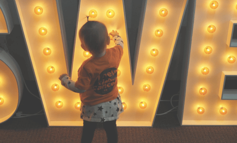 baby playing with the light bulbs at Radiothon 2023