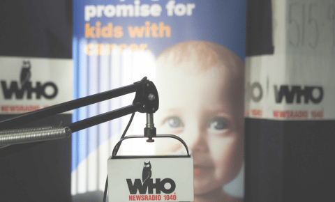 A close up of the WHO Radio mic and a Pinky Swear Foundation sign in the background.