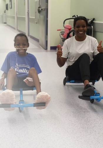 All-Star Aamir and his mom riding scooters down the hospital hallway