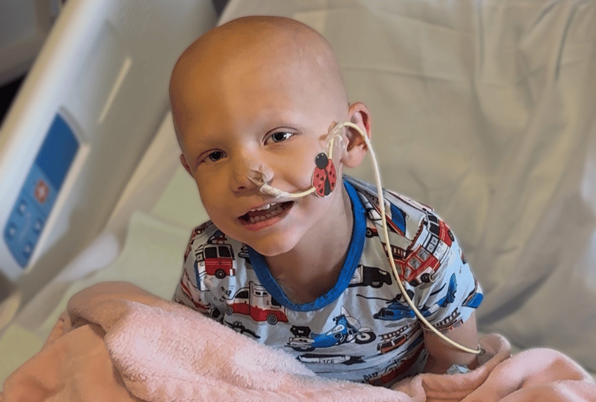Gryffin in hospital bed with feeding tube