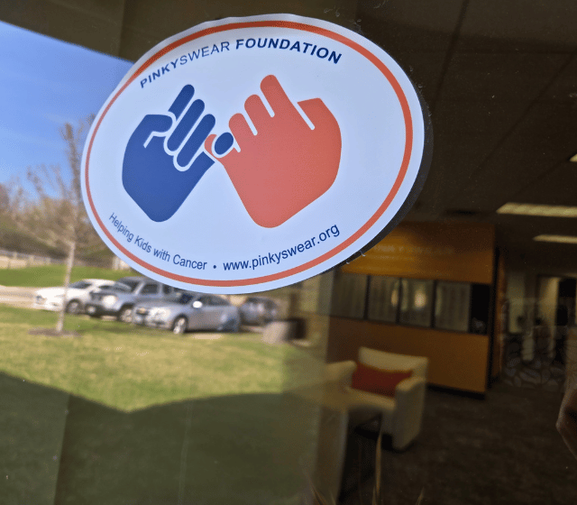 A sticker at the Pinky Swear office with the logo on it