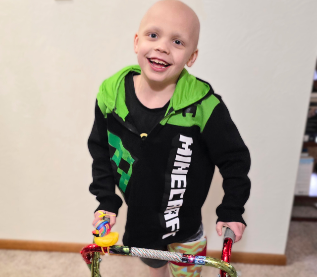 A boy named Wilson with a walker after losing his leg to cancer.