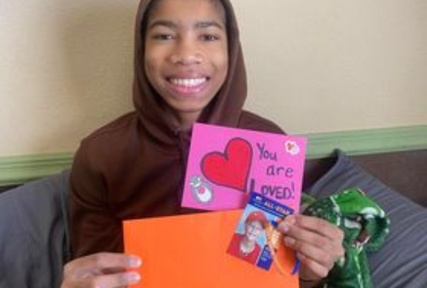 All-Star Skyler holding the contents of the Orange Envelope
