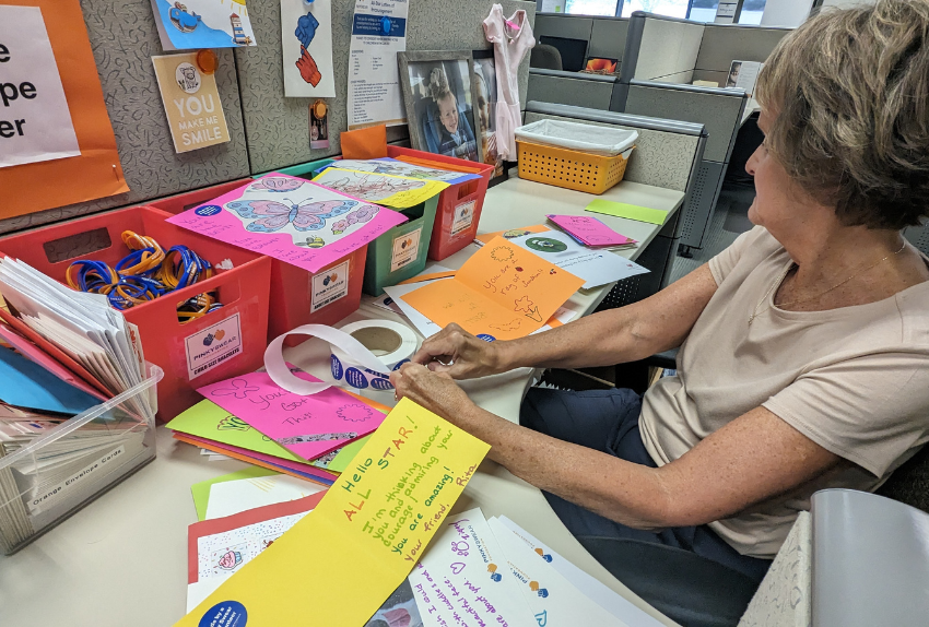 A volunteer placing stickers