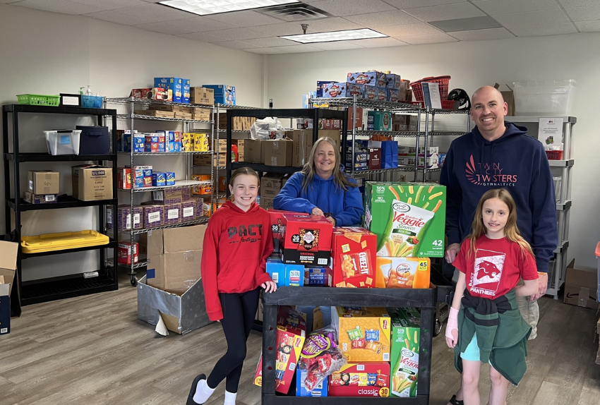 A group of volunteers standing with their pantry donations