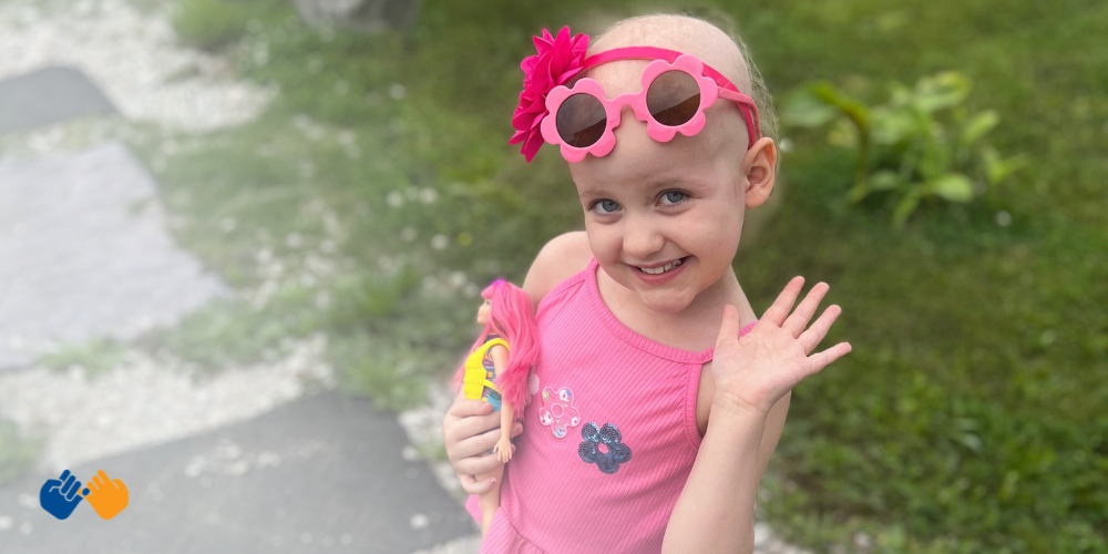 A little girl named Scarlett waving at the camera