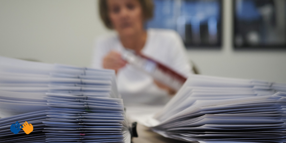 A stack of Orange Envelope payments going to families facing childhood cancer.