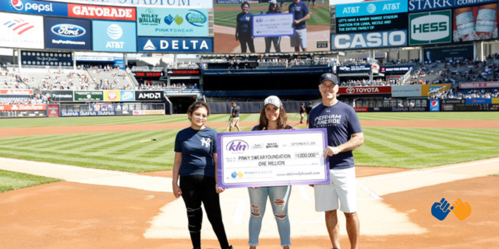 Charlie Nelson with a check to Pinky Swear Foundation at a Yankees game