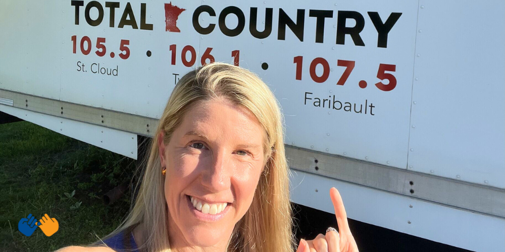 Pinky Swear Foundation Executive Director Erica Campbell in front of the Total Country BOB FM truck.