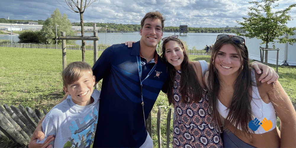 A teen who faced a brain tumor with his three siblings smiling at the camera