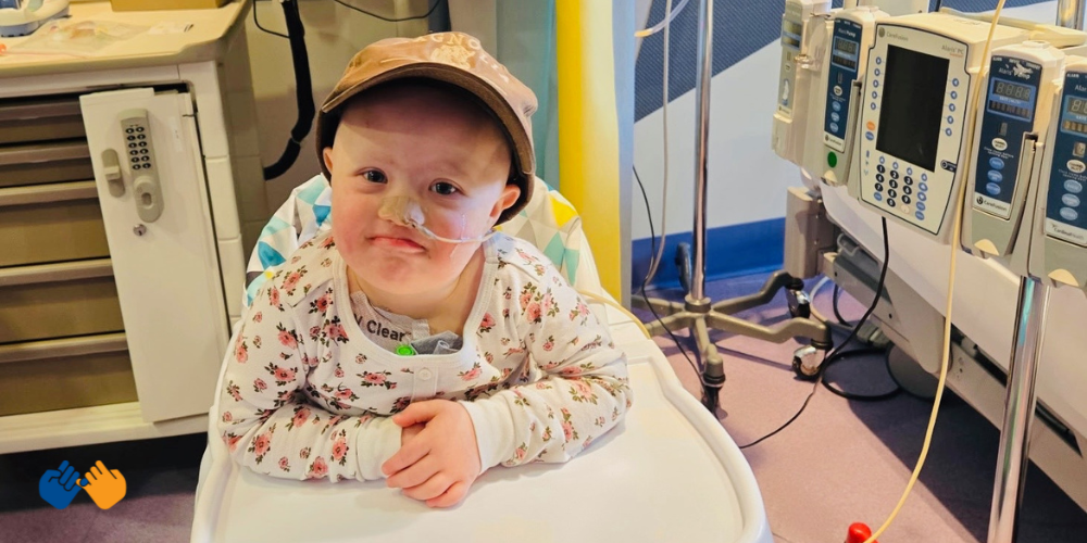All-Star Kayla sitting in a high chair in the hospital