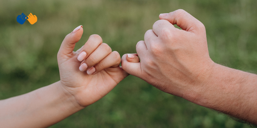 Two people doing a pinky swear with a Pinky Swear Foundation logo in the corner of the image.
