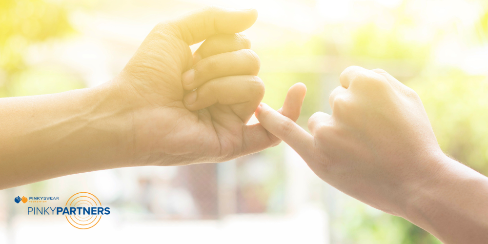 two people doing a pinky promise