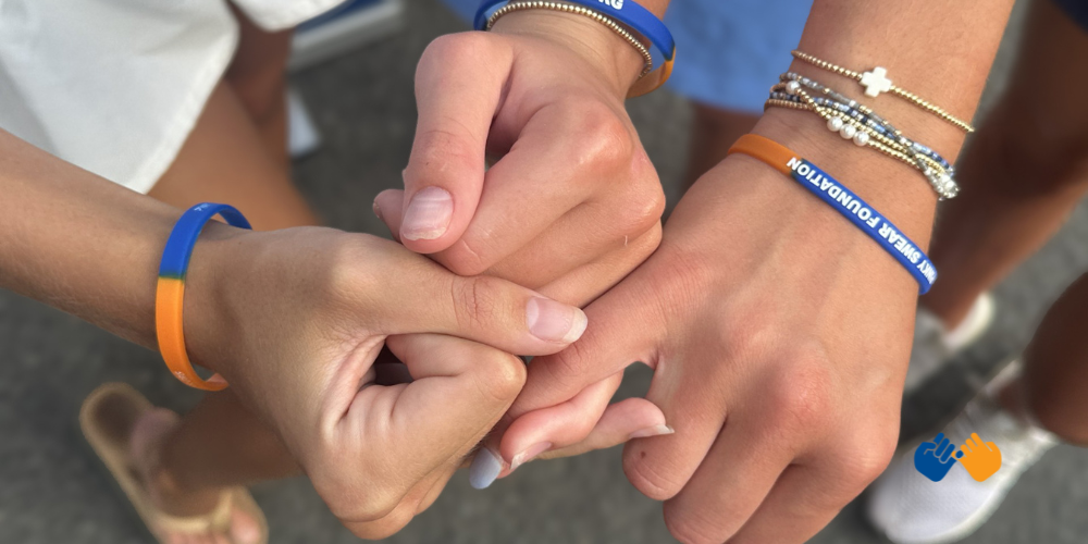 Three teens making a pinky promise to represent Pinky Swear Foundation, a nonprofit on a mission to help kids with cancer and their families financially.